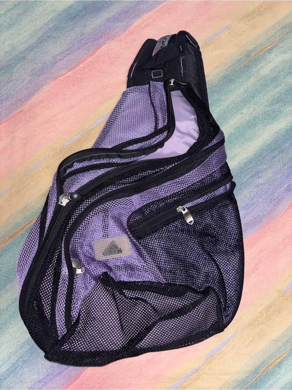 Adidas black/purple nylon, mesh sling one shoulder backpack.